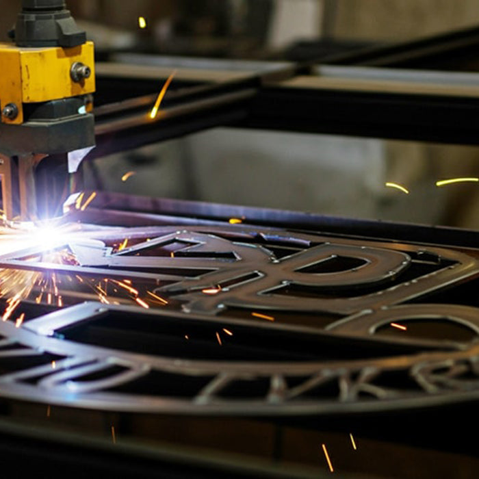 Laser cutting machine in action with metal cutting, sparks flying.
